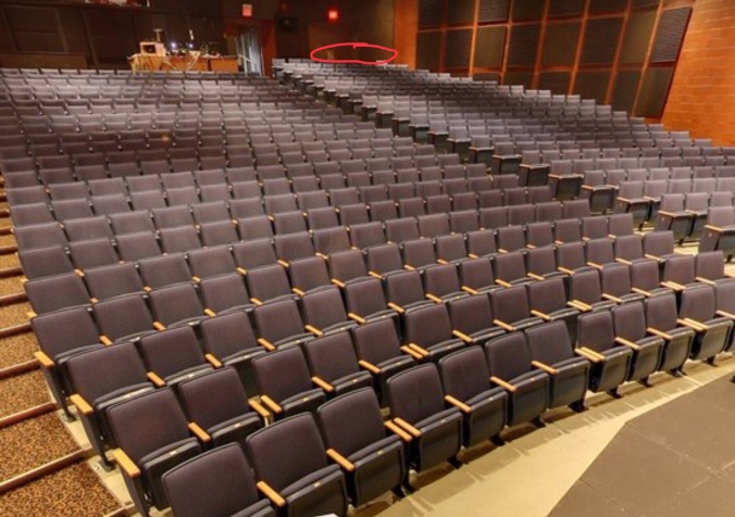 photo of seats in the auditorium with highlighting on the far right of the back row