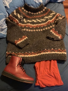 Brown sweater, orange leggings and a Doc Marten boot