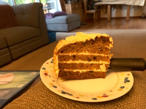 A large slice of carrot cake on a plate