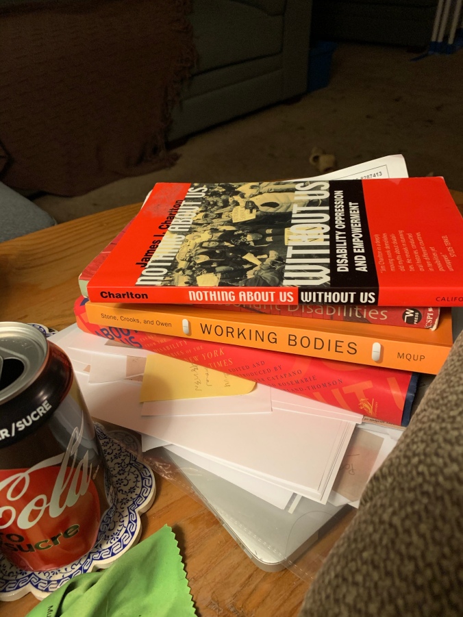 Books, papers, laptop, Diet Coke can